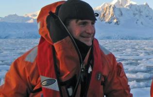 Professor Dan Crocker in diving gear in on icy water