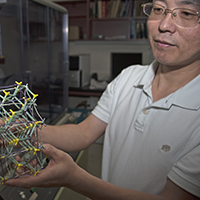 Physics professor holds a 3D model